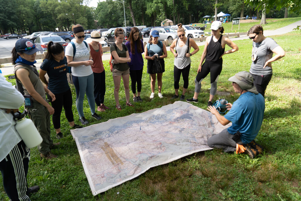 Students in the field learning around a map