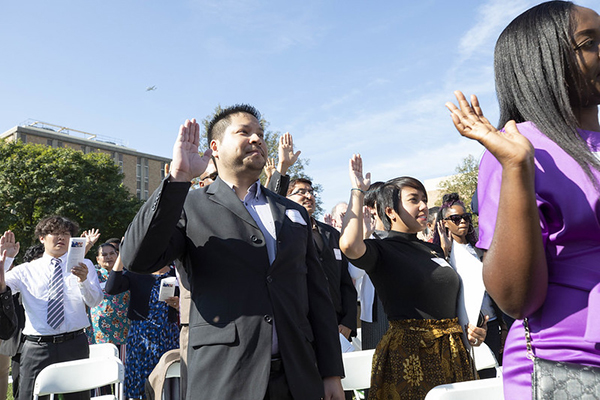 New citizens taking part in the naturalization oath ceremony