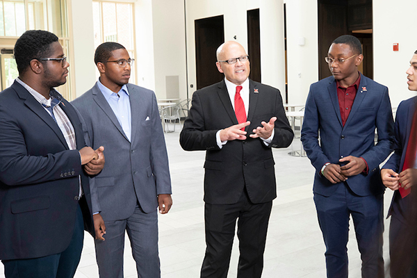 Dr. Crawford speaking with a circle of students, including Justice Hubbard