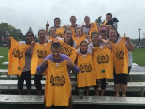 Winner students holding up shirts 