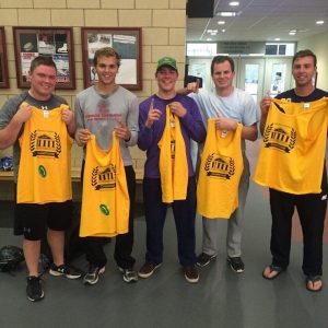 broomball players holding up shirts