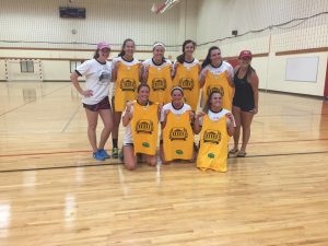 volleyball players holding up shirts