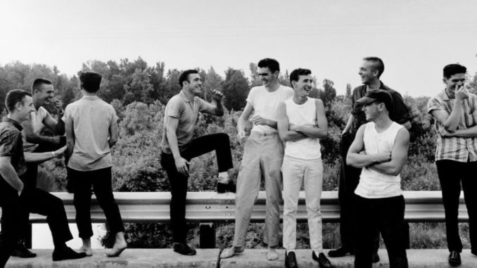 Photo of boys laughing on a bridge.