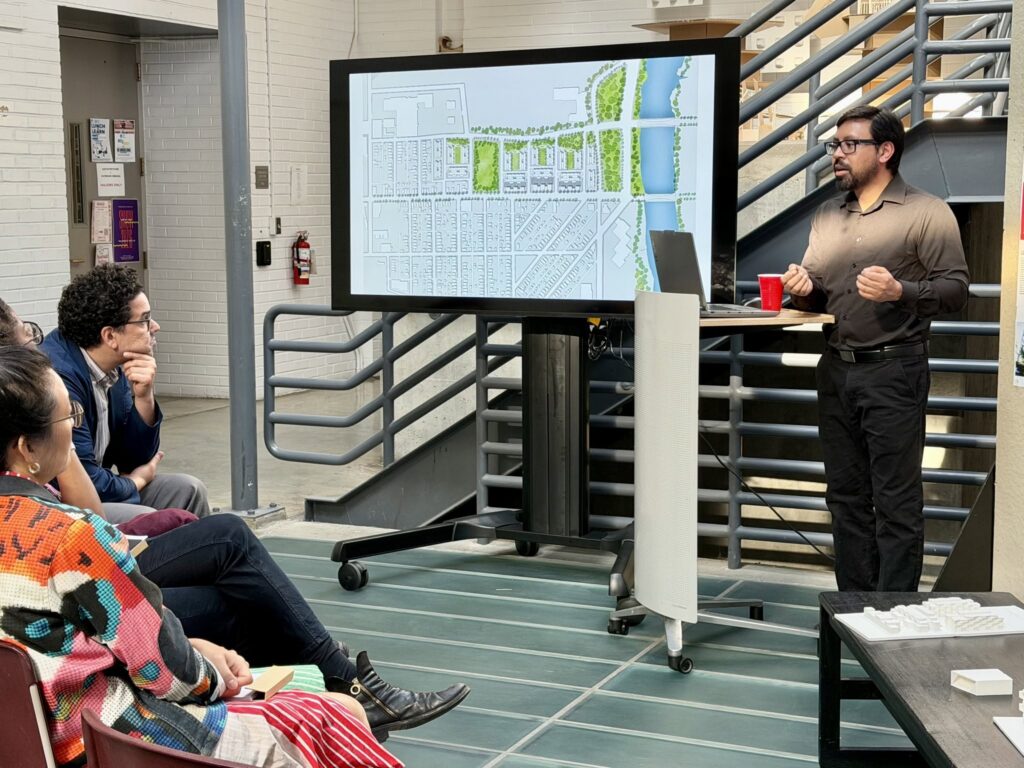 Graduate architecture student presenting to other students and faculty.