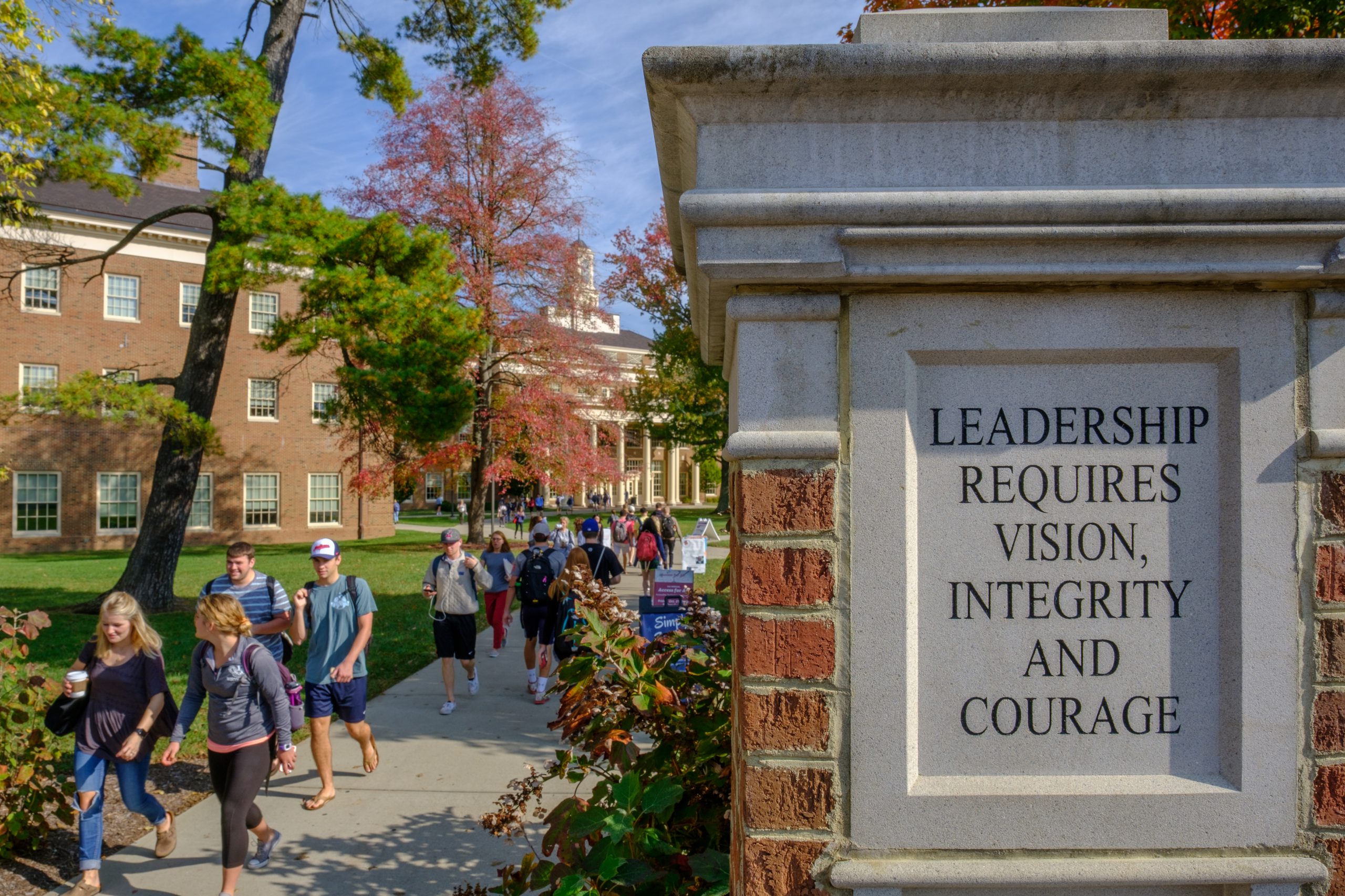 Pillar next to walkway to Farmer School of Business States Leadership requires vision, integrity, and courage