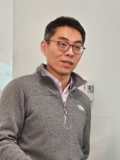 Close-up photo of Professor Po-Chang Chen speaking during a presentation.