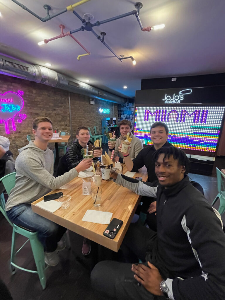 A group of students seated around a restaurant table