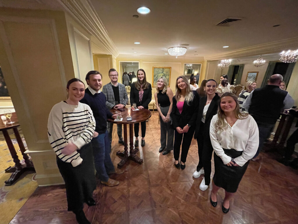 A group photo of students and professionals in a relaxed setting