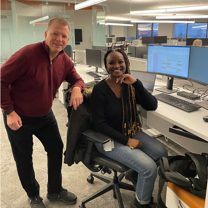 Photo of Professor Brian Ballou with 2022 ELCE participant Nana Hemaa at her workstation.