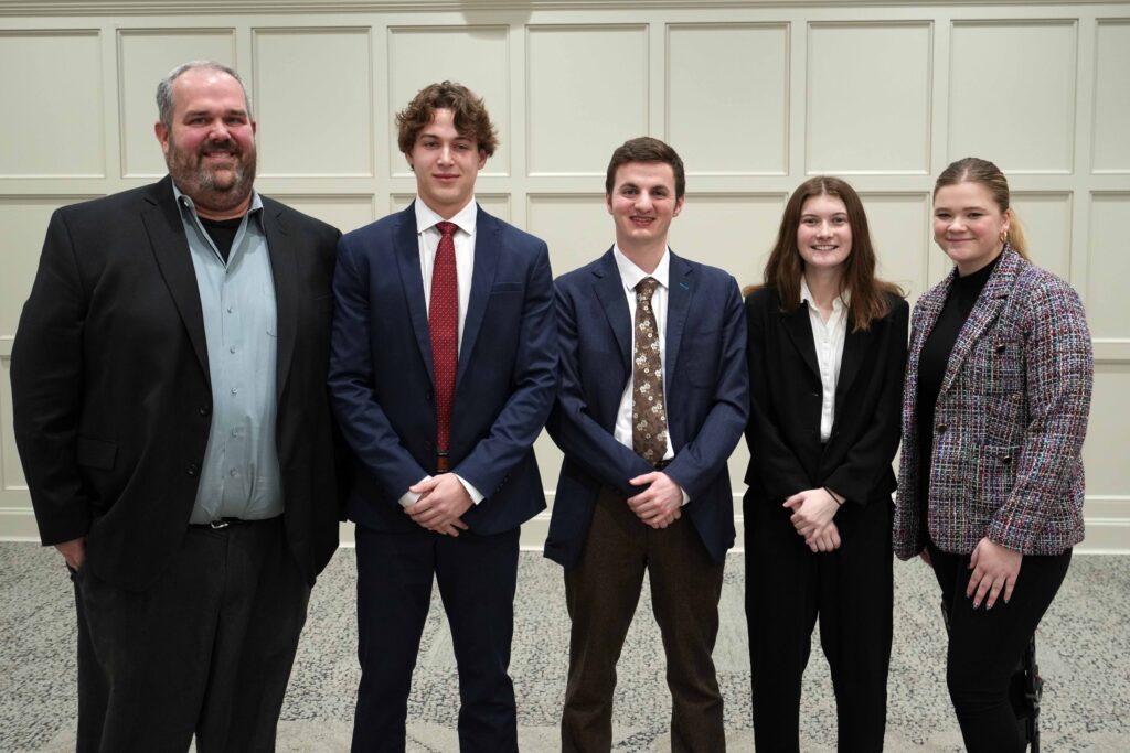 Group photo of Accountancy Professor Jon Grenier with the winning team