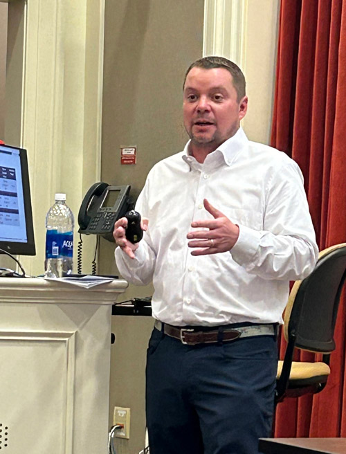 Photo of Paul Shade speaking at a class lectern