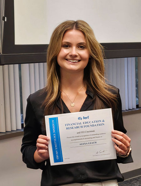 Photo of Alexa Leach holding her certificate