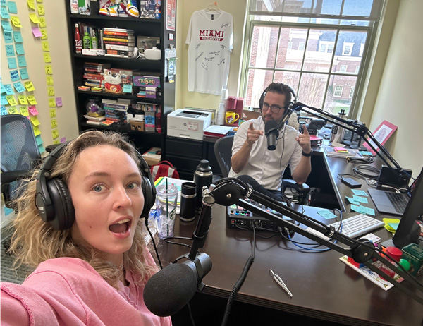 Photo of Ally and Justin recording for a podcast