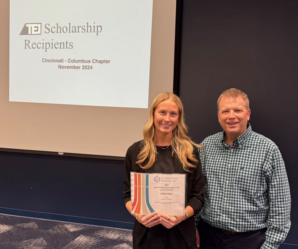 Photo of Juliana Finley and Brian Ballout at the awards ceremony, with Juliana holding her certificate. 