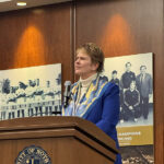 Anne Farrell speaking at a podium