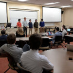 A group of students presenting in front of their class