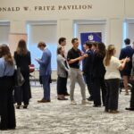 Meet the Firms photos show groups of students interacting with recruiters