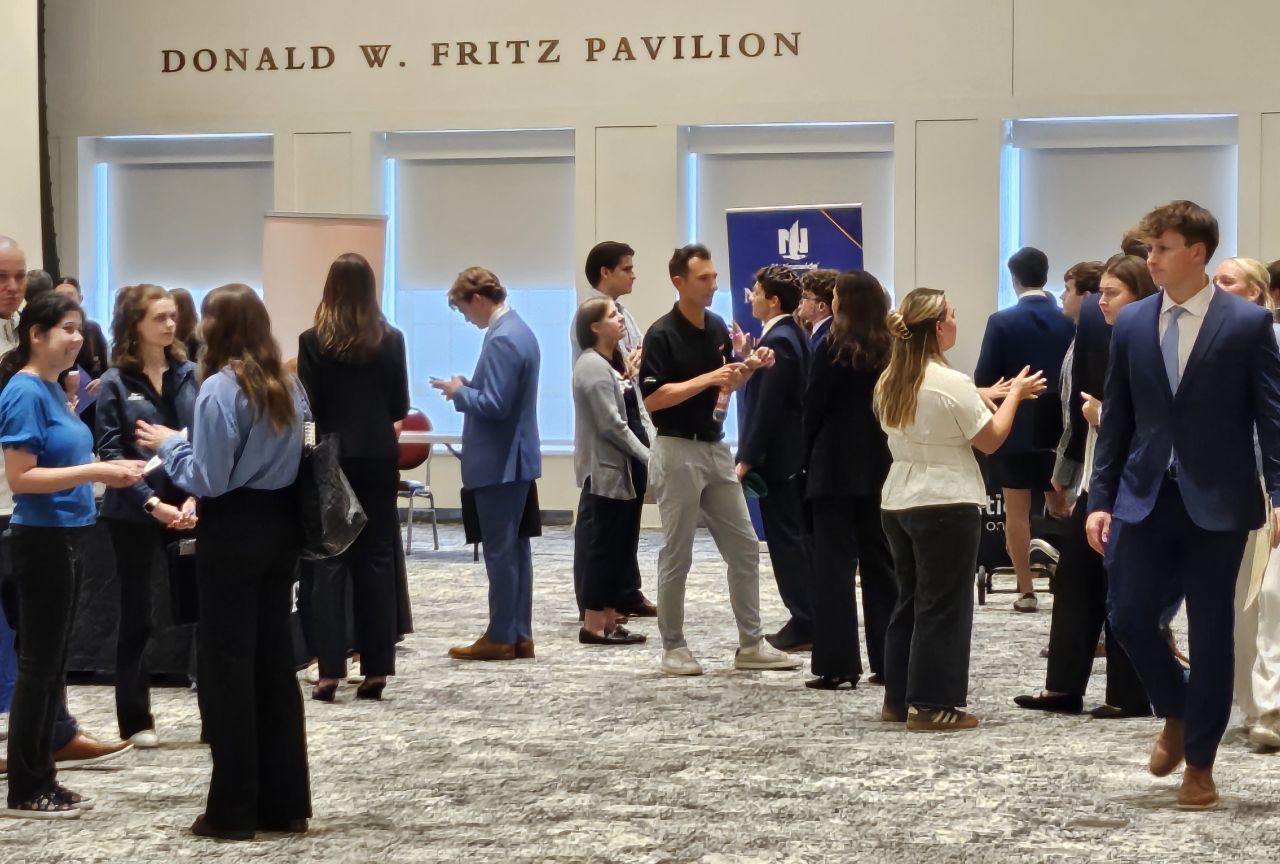 Meet the Firms photos show groups of students interacting with recruiters