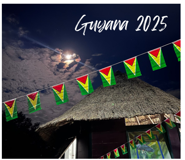 A hut with a evening background with Guyana 2025 written in white text on it.