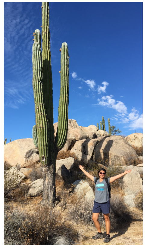 Jessie standing next to a very large cactus in Baja, México