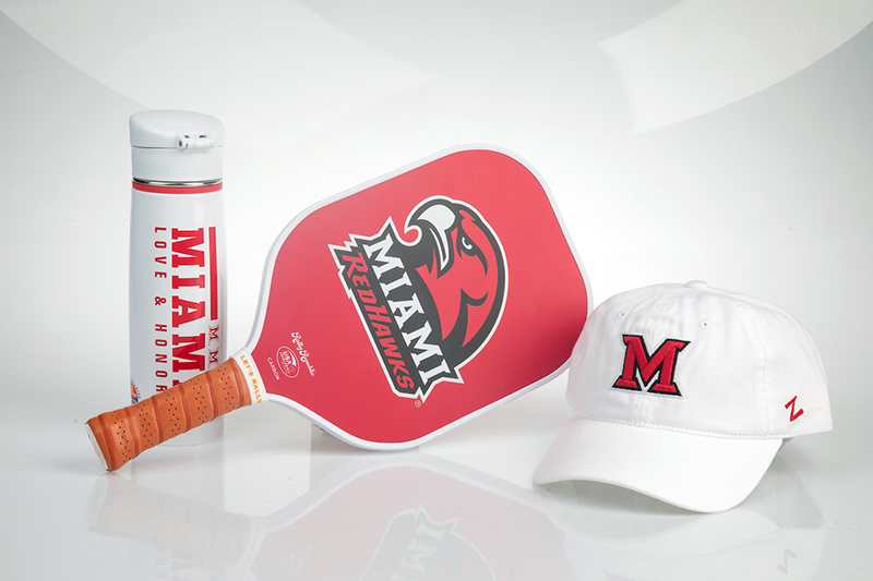a branded water bottle, pickleball paddle, and hat