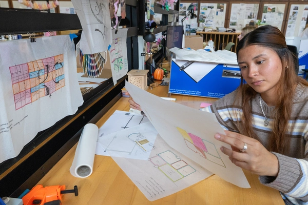 student reviewing designs