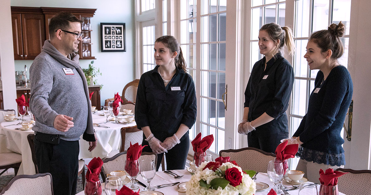 A banquet manager giving instructions to the staff before event begins
