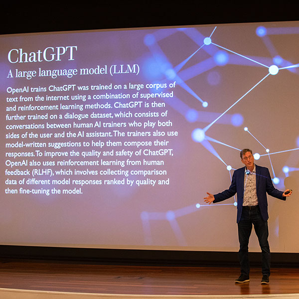 A person giving a presentation on Chat GPT and Open AI.
