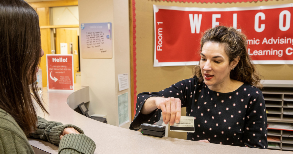 Stephanie swiping card for a student.