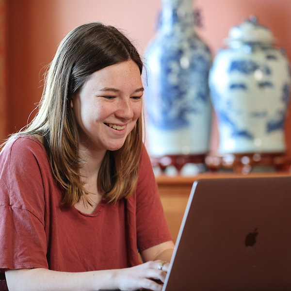 A female graduate student participating in an online class