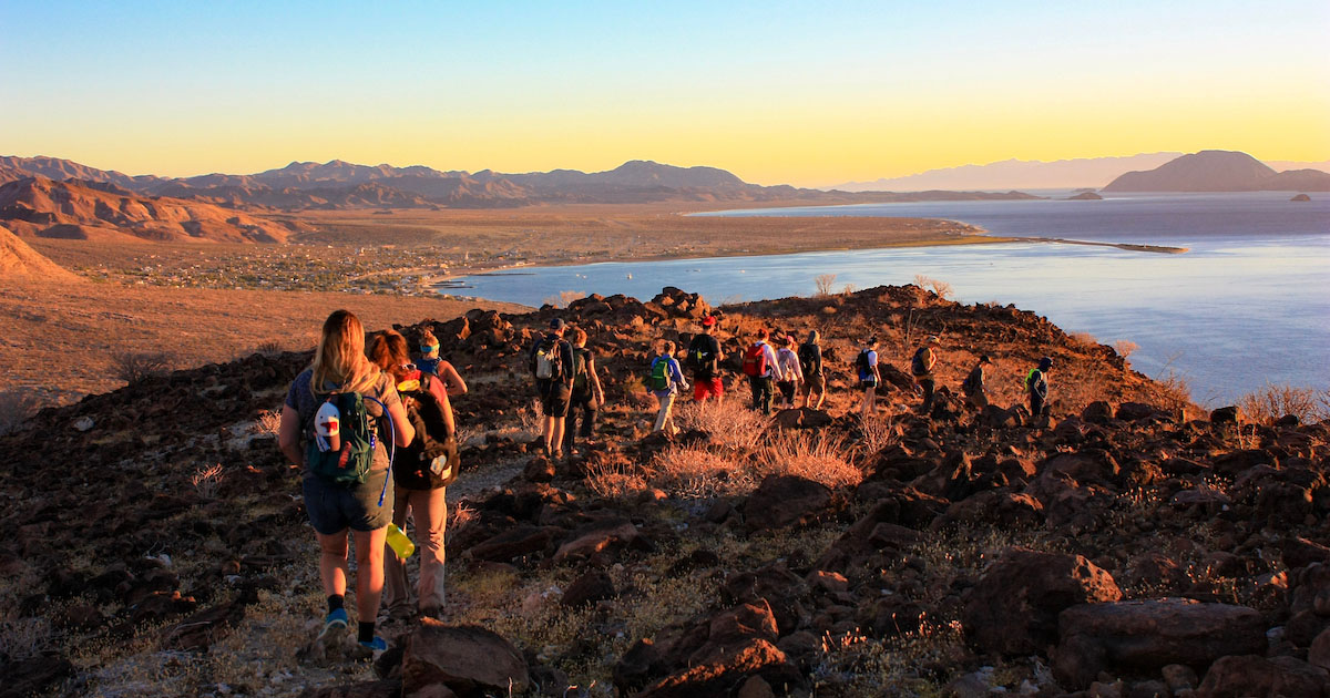 A group Project Dragonfly students hiking toward water in Baja