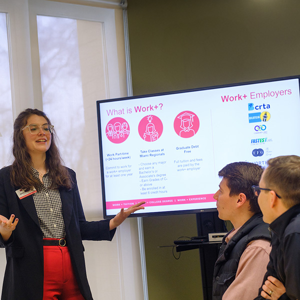 A Miami University Regionals staff member leads an info session about Work+ with two adult students.