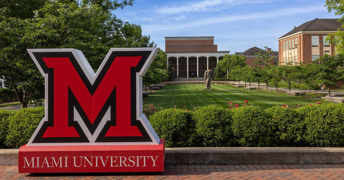 Relaxing summer Miami University campus scene with a life-size Beveled M in the foreground.