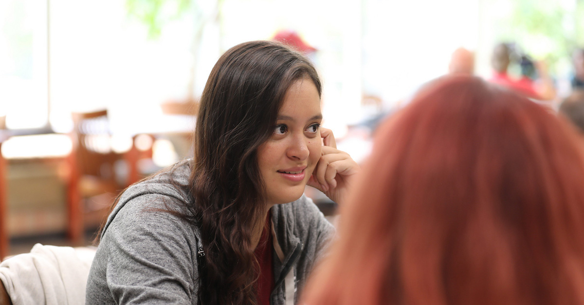 A woman online student who is deep in thought