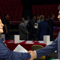 A Miami student shaking hands with a potential employer