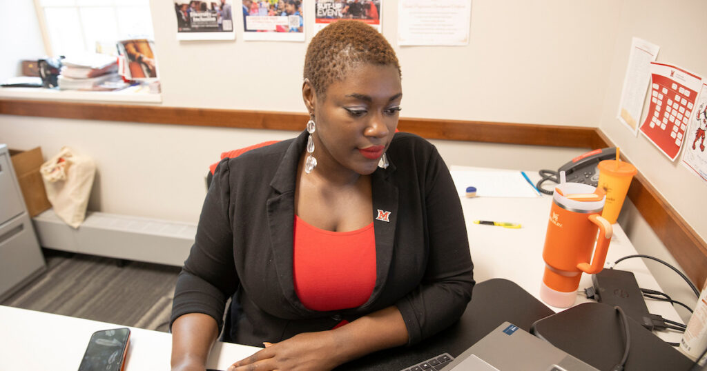 A woman working on her graduate online business certificate
