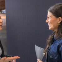 Two women talking at career networking event