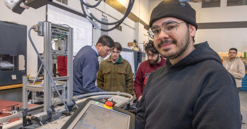 A young man working on a manufacturing certificate.