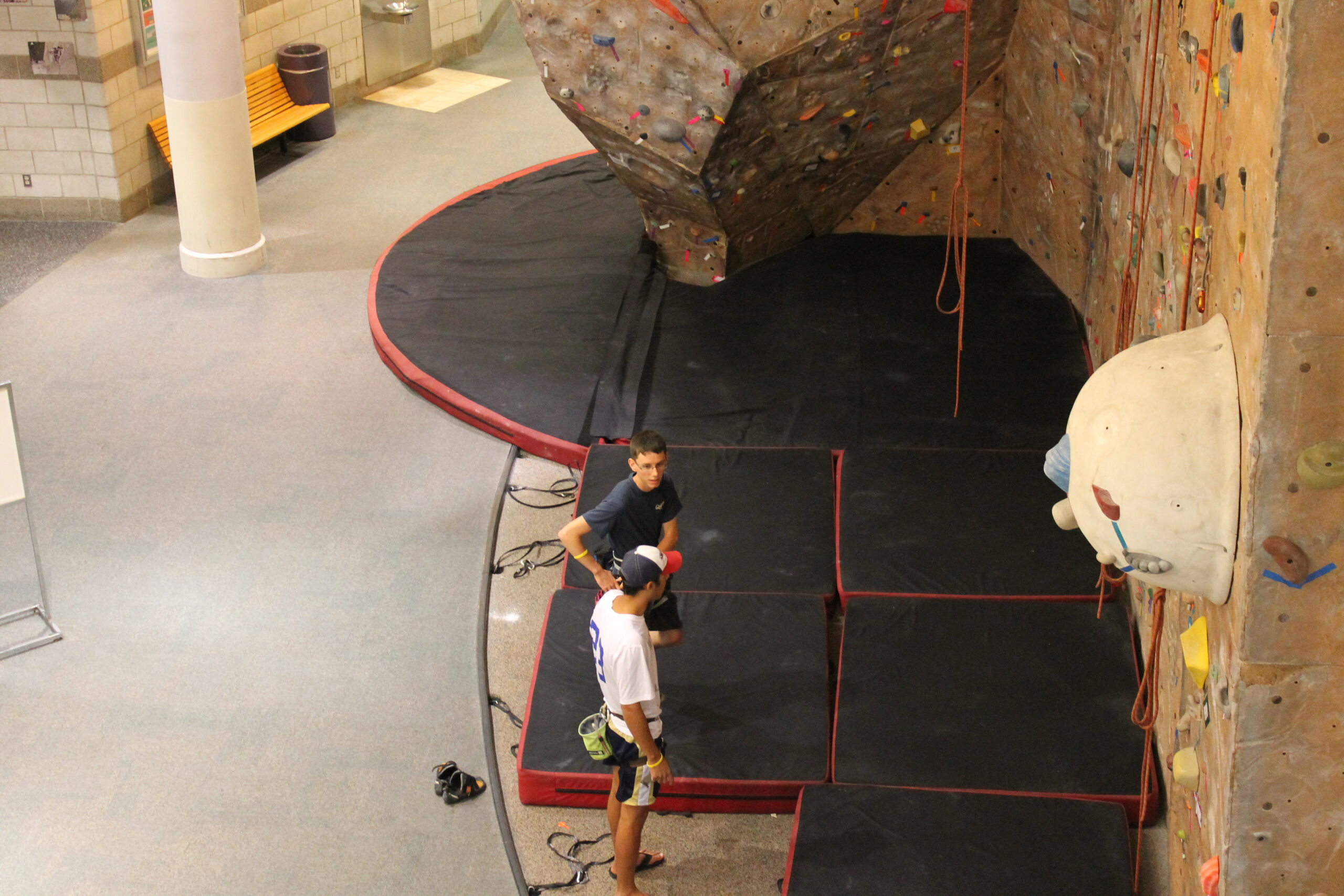 two students about to climb climbing wall