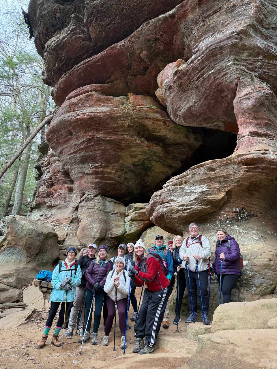 Move Beyond Surviving women posed in front of a giant, curving rock formation