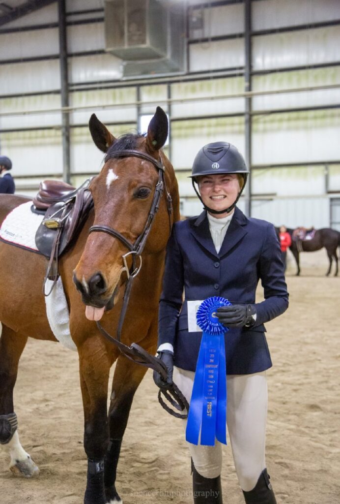 Annika and her horse with a first place ribbon