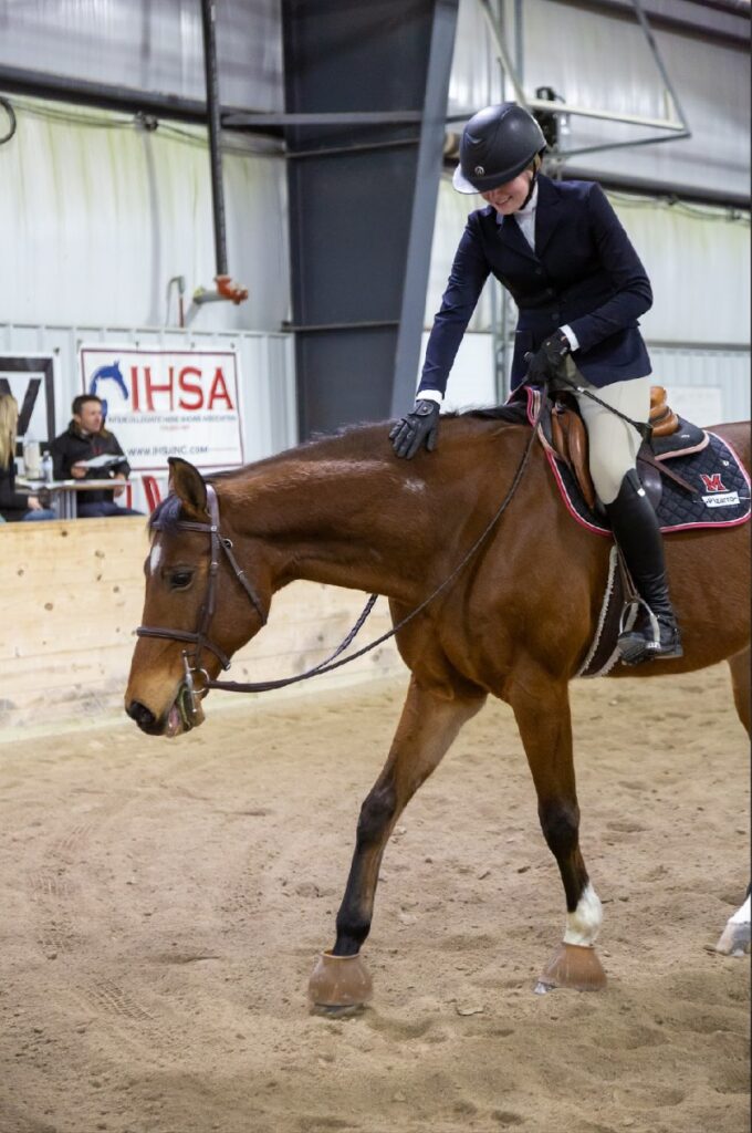 annika on horse inside equestrian center