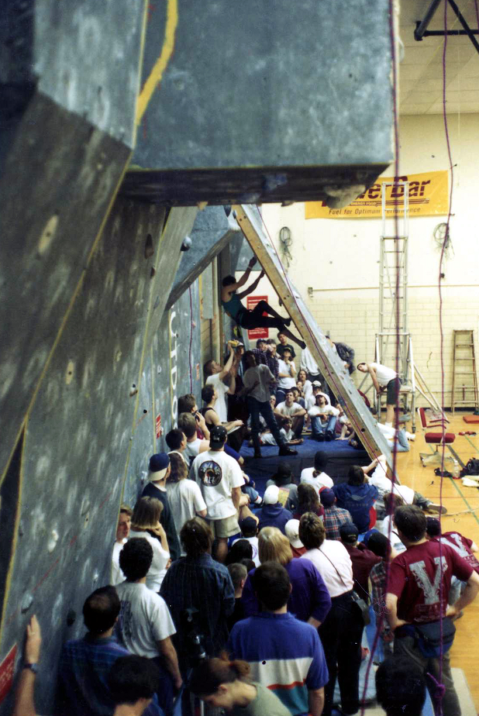 A climbing competition at Withrow Court in 1994, during which Tim Steele climbs on the backside of the slab wall while an enthralled crowd watches. (Photo courtesy of Tim Steele)
