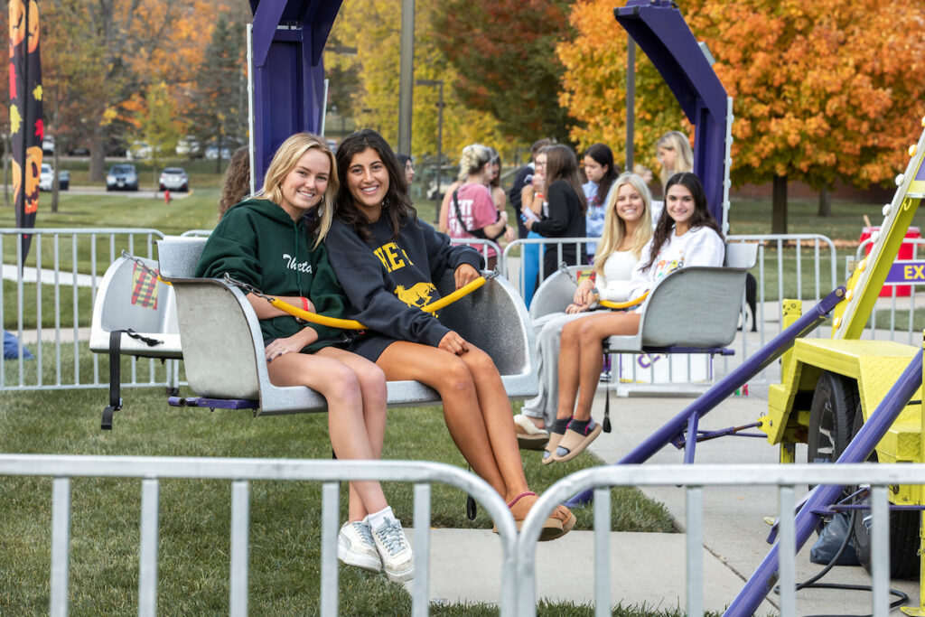 Students riding a carnival ride on rec quad