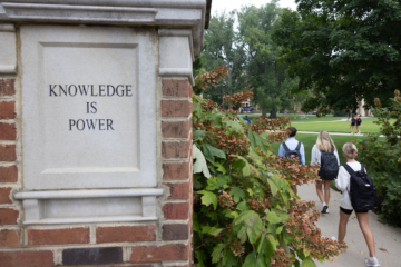 Farmer School of Business walkway entrance, with brick pillar that reads Knowledge is power.