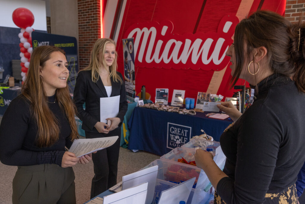 A student talking to a recruiter at a career fair. 
