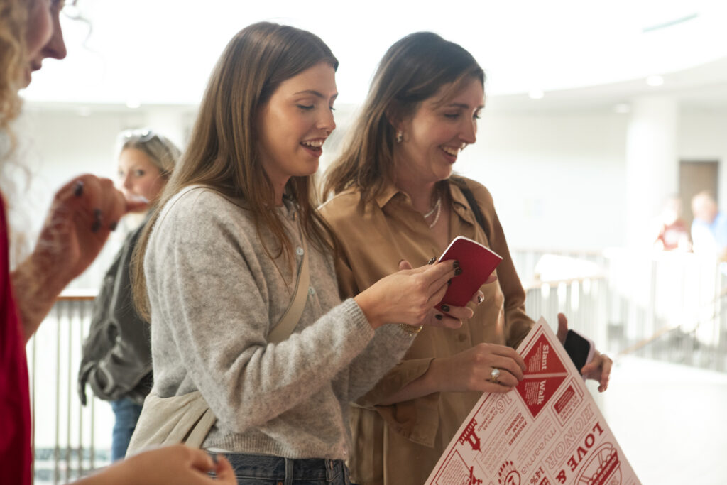 Two women smiling looking at Miami merch