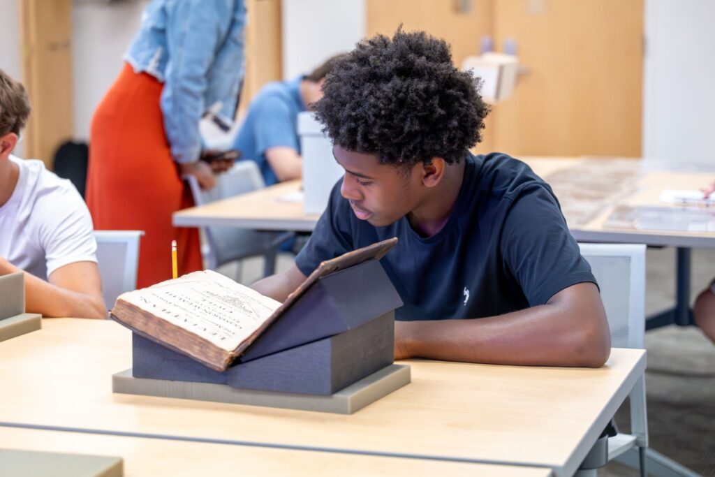 A student reading a historic book