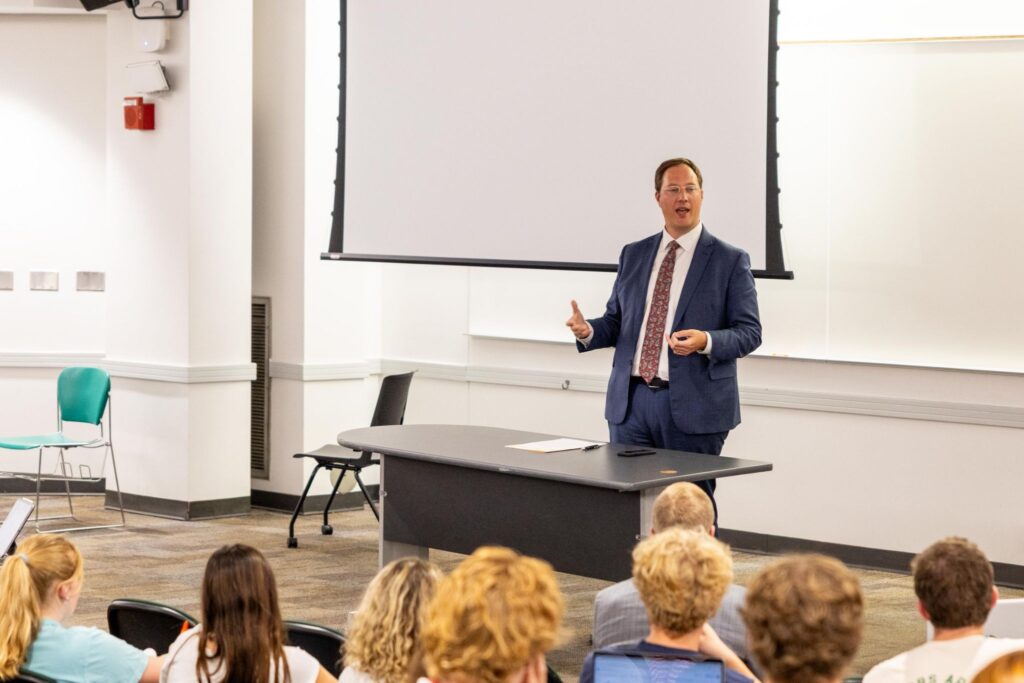 Professor presenting in front of a class. 