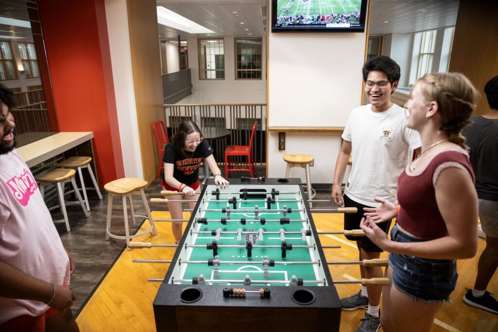 A group of students playing foosball.